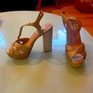 Gold sparkle Steve Madden platform heels.